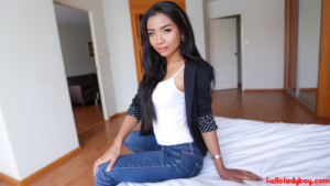Gorgeous passable Ladyboy poses in jeans and tank top