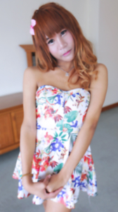 Waii strikes seductive pose wearing flower print dress