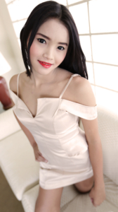 Ice poses on the couch in white dress