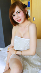 Petite sensual Yuri B looking feminine in white dress while posing in bed