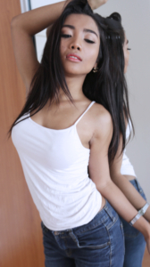 Feminine Lee Ya poses in tank top and tight jeans