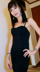 Poy posing her shapely body in black dress